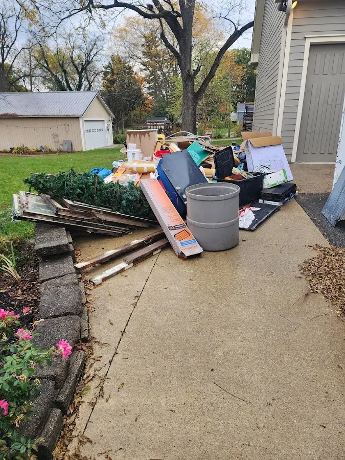 Dumpster being loaded with debris for 12 Yard Dumpster Rental in Osceola